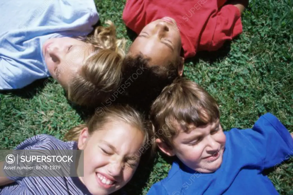 Group of children lying on a lawn