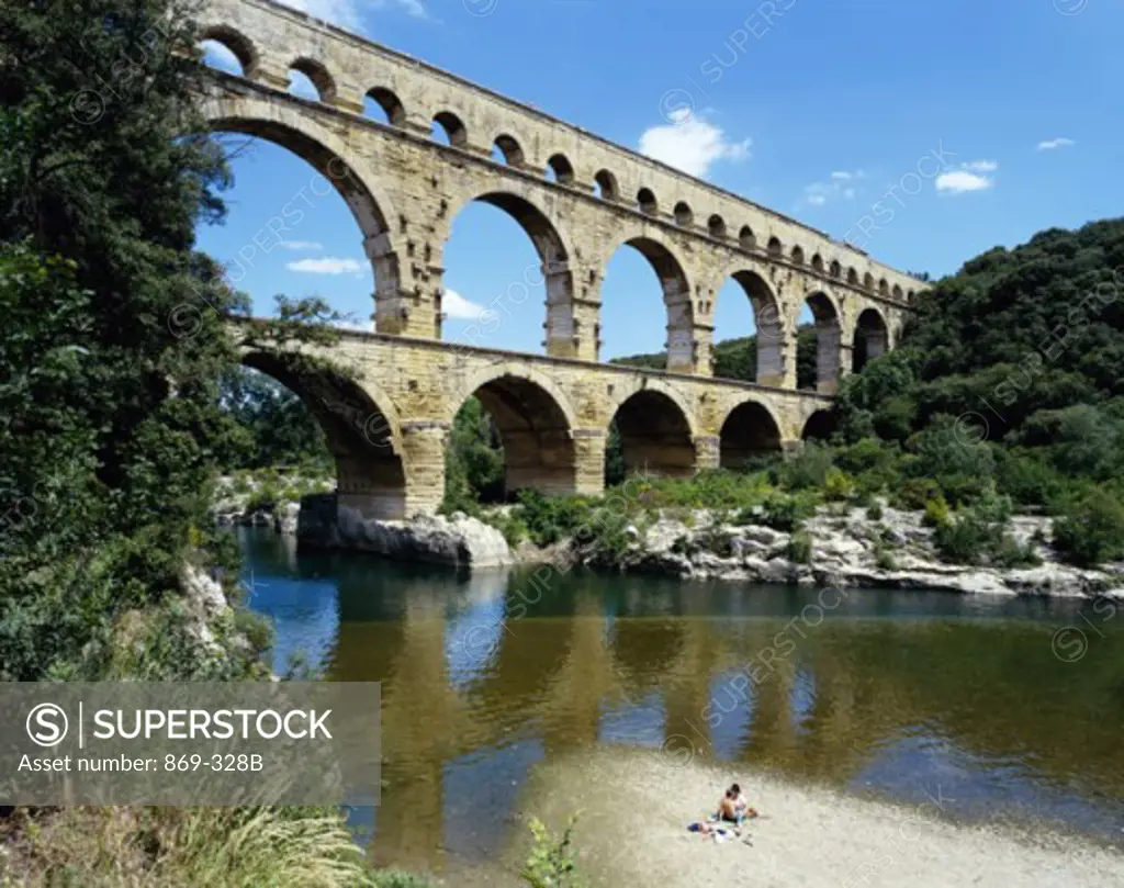 Reflection of an aqueduct in water, Pont du Gard, Nimes, France