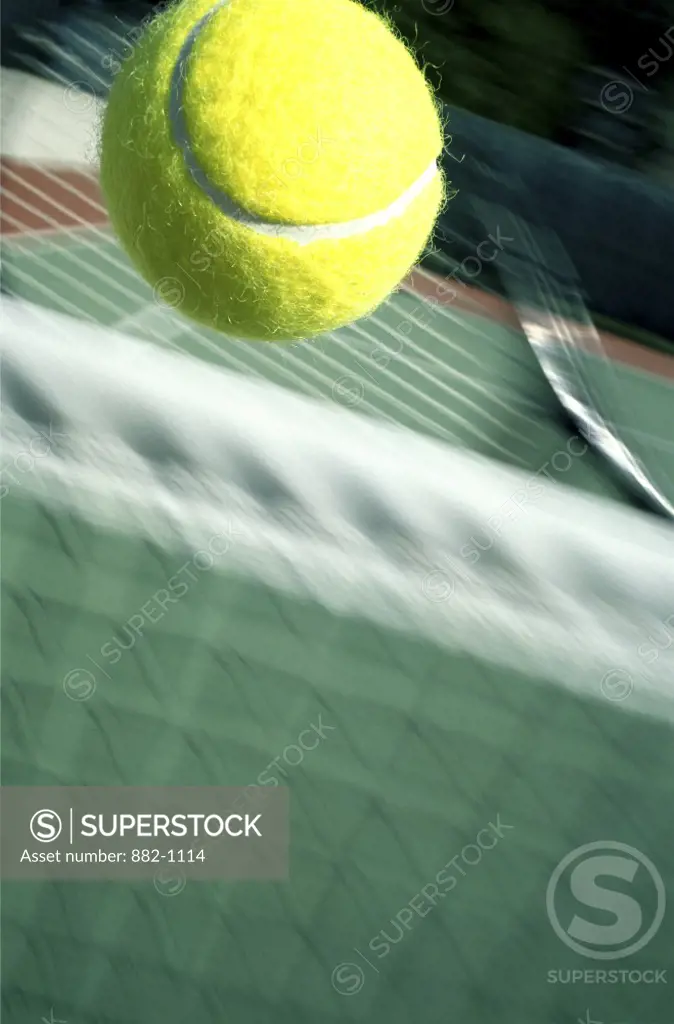 Close-up of a tennis ball over a tennis net