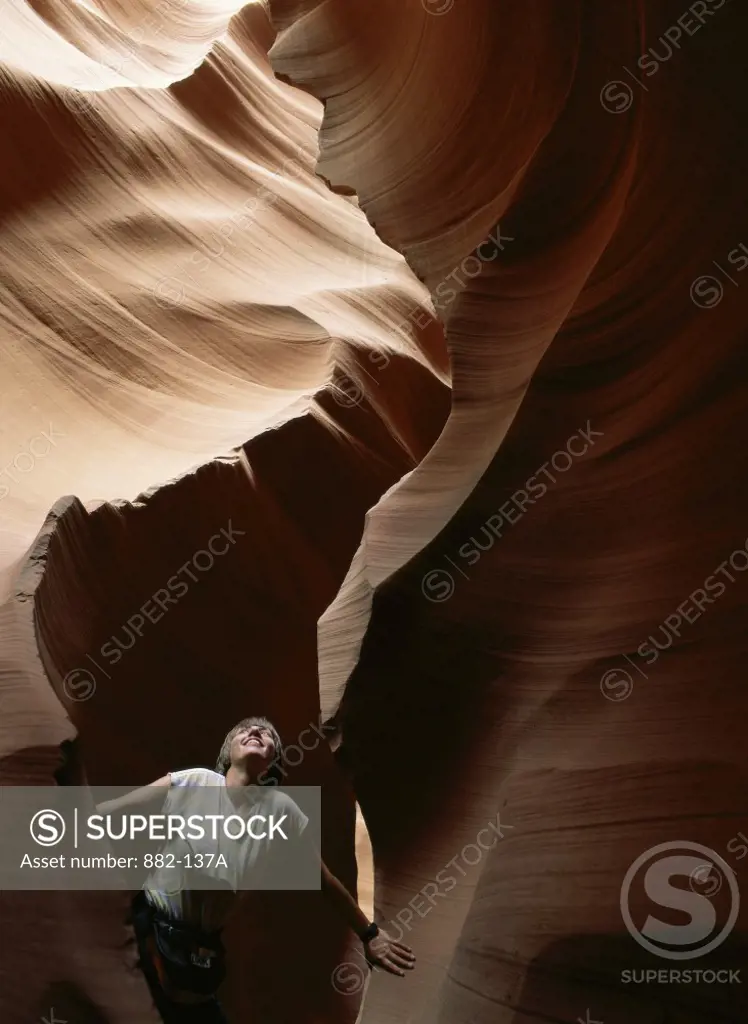 High angle view of a woman standing in a canyon, Slot Canyon, Arizona, USA