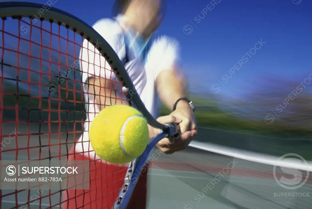 Tennis player hitting a tennis ball