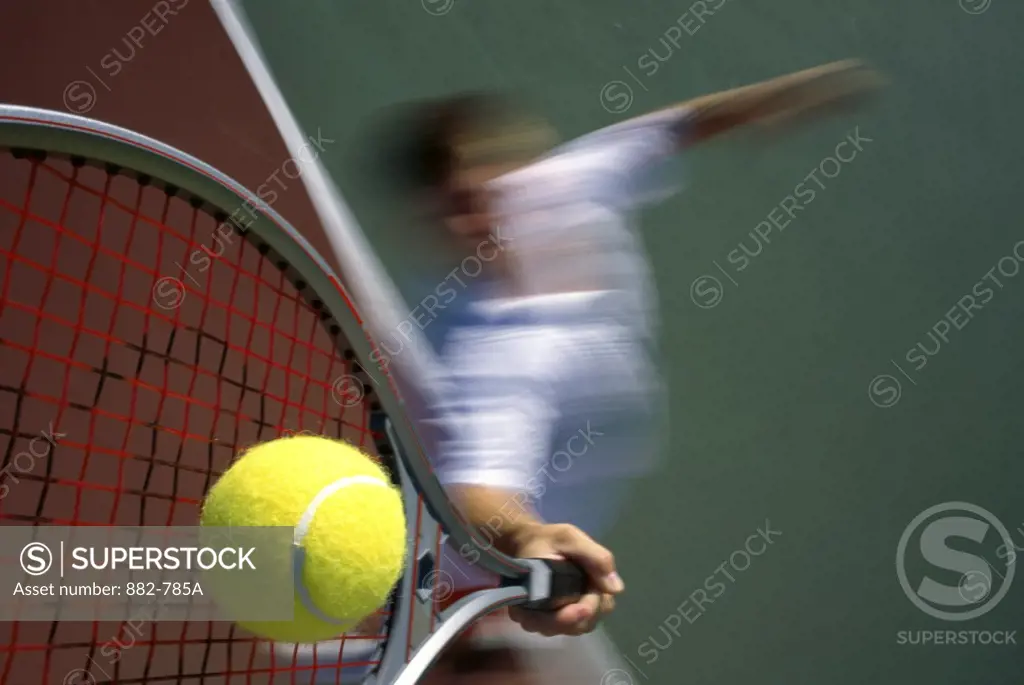 Tennis player serving a tennis ball