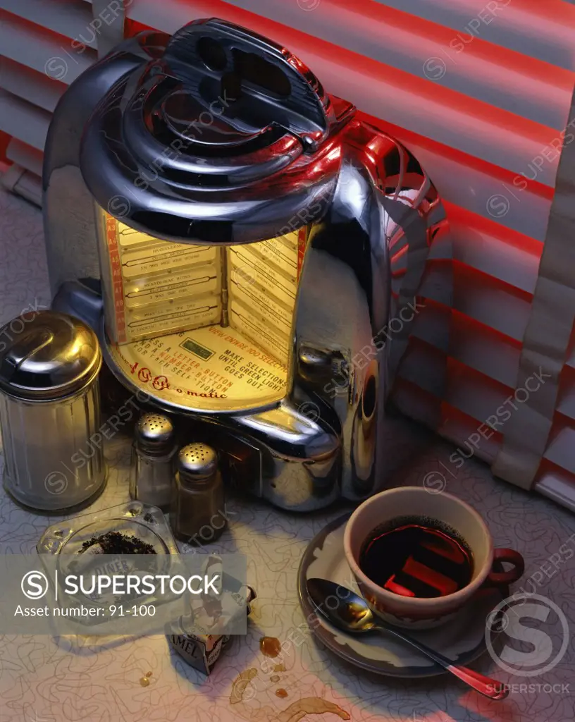 High angle view of a jukebox with a coffee cup