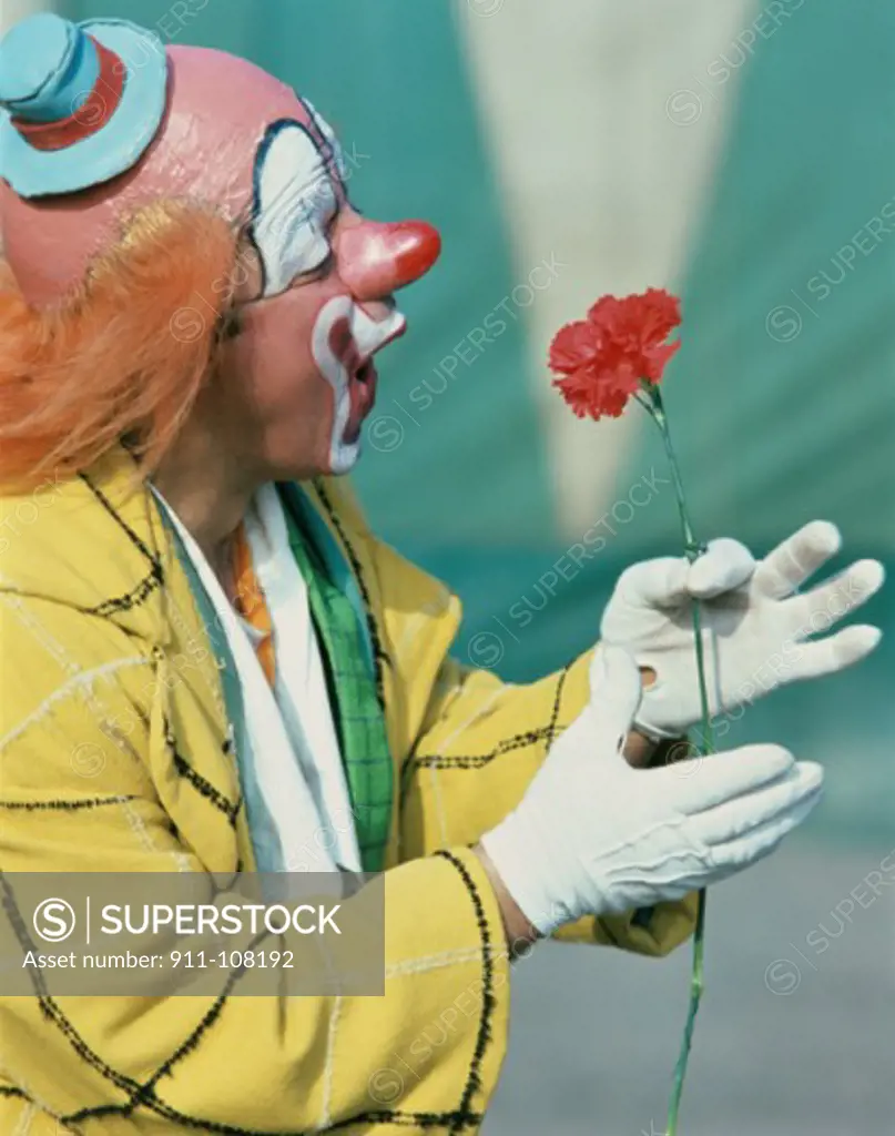 Close-up of a clown holding a flower