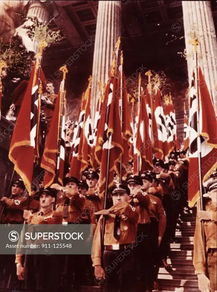 Army soldiers carrying Nazi flags in a parade