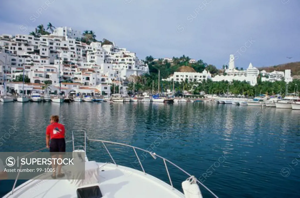 High angle view of a man standing on a boat, Las Hadas Golf Resort and Marina, Manzanillo, Mexico