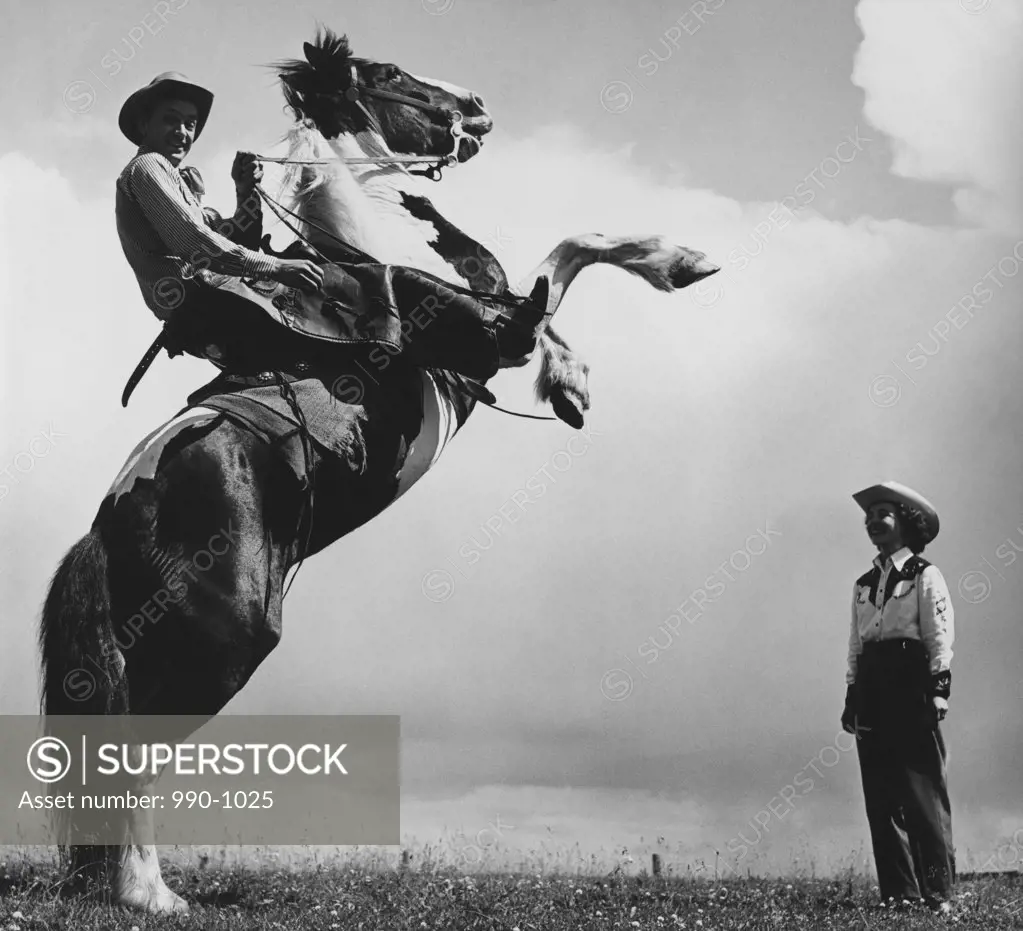 Low angle view of a cowboy riding a bucking horse