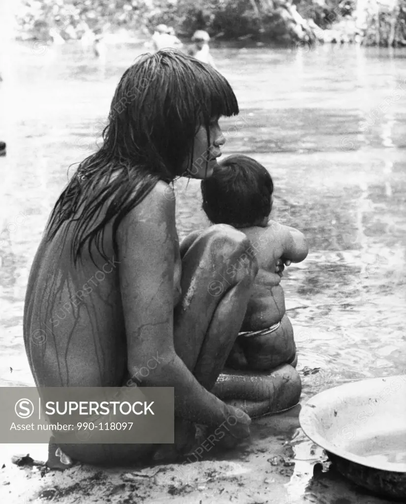 Mid adult woman bathing with her child, Mato Grosso, Brazil