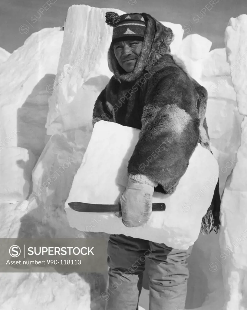 Mid adult man holding a block of ice