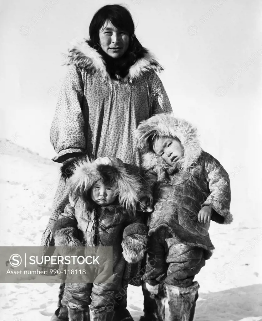 Mid adult woman with her two sons standing on snow
