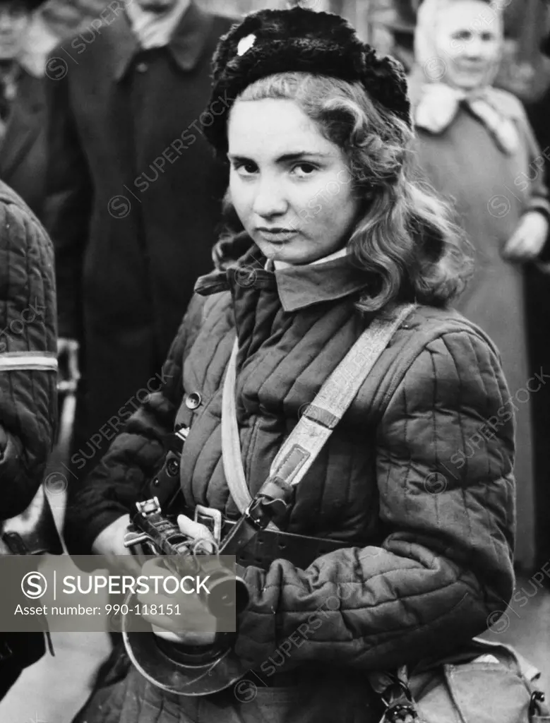 Teenage girl holding a handgun, Budapest, Hungary, 1956