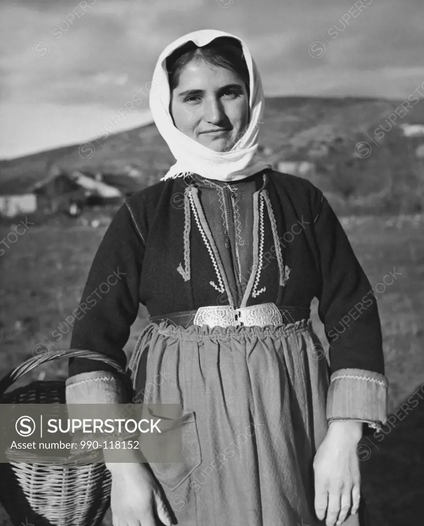 Young woman carrying a basket, Orestiada, Greece