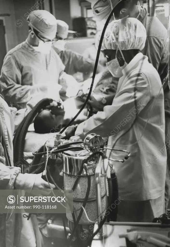 Nurse checking the blood pressure of a patient in an intensive care unit