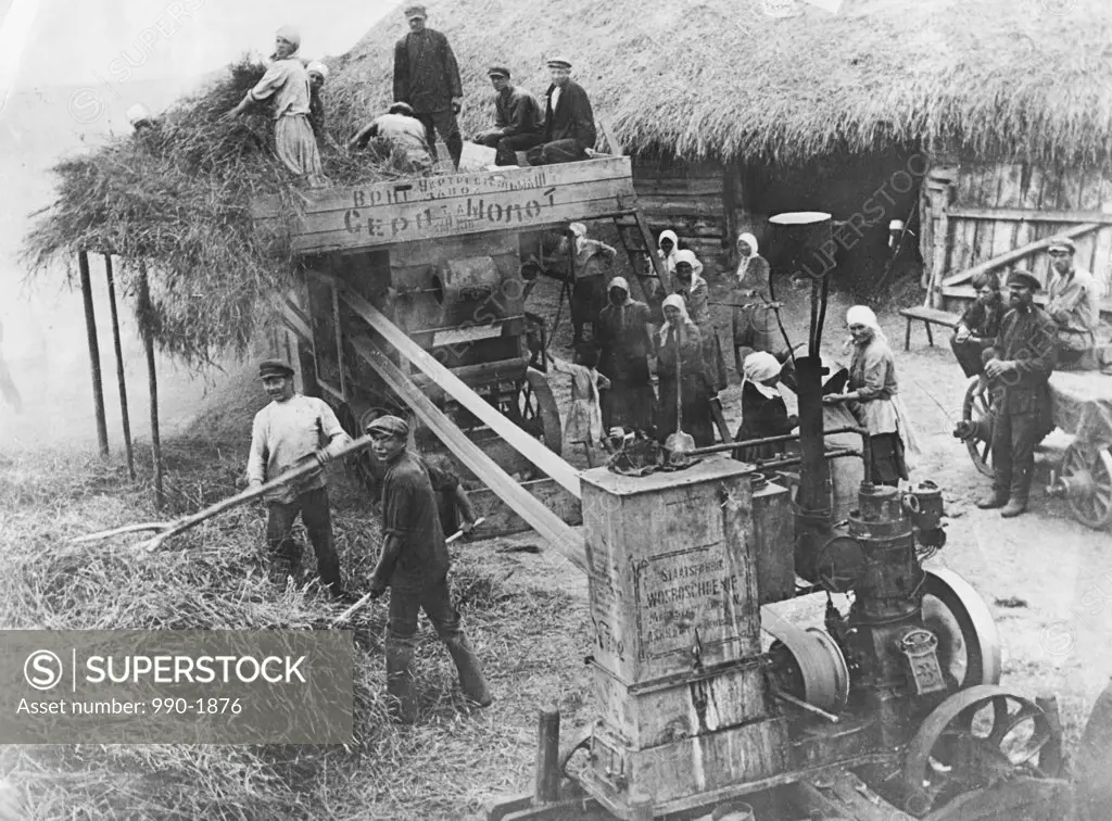 Group of farmers working on a harvester
