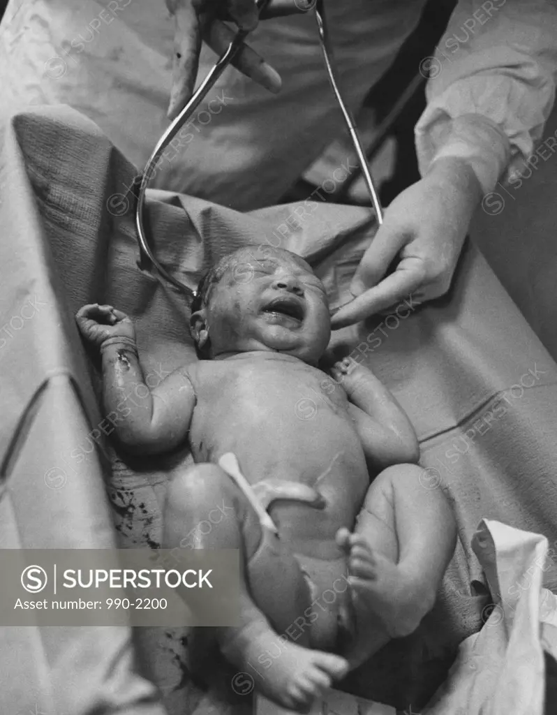 Nurse measuring a newborn baby's head
