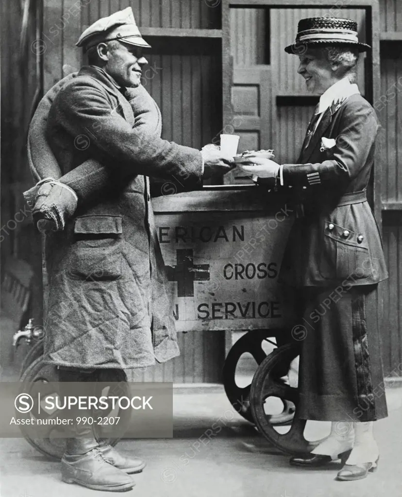 Red Cross worker giving food to a Polish-American soldier, 1918