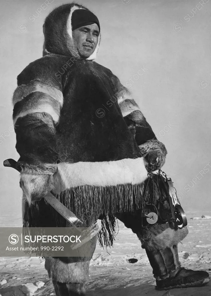 Eskimo man holding an axe, Northwest Territories, Canada