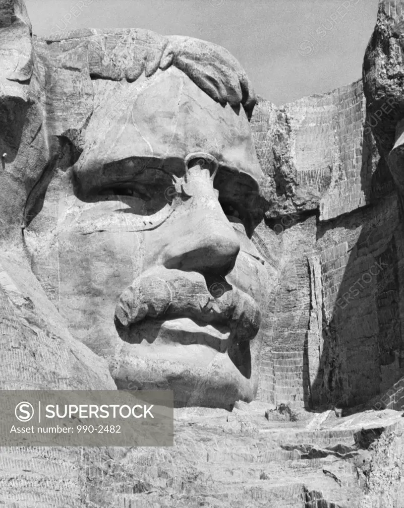 Low angle view of a sculpture of Theodore Roosevelt carved on a rock, Mount Rushmore National Memorial, South Dakota, USA