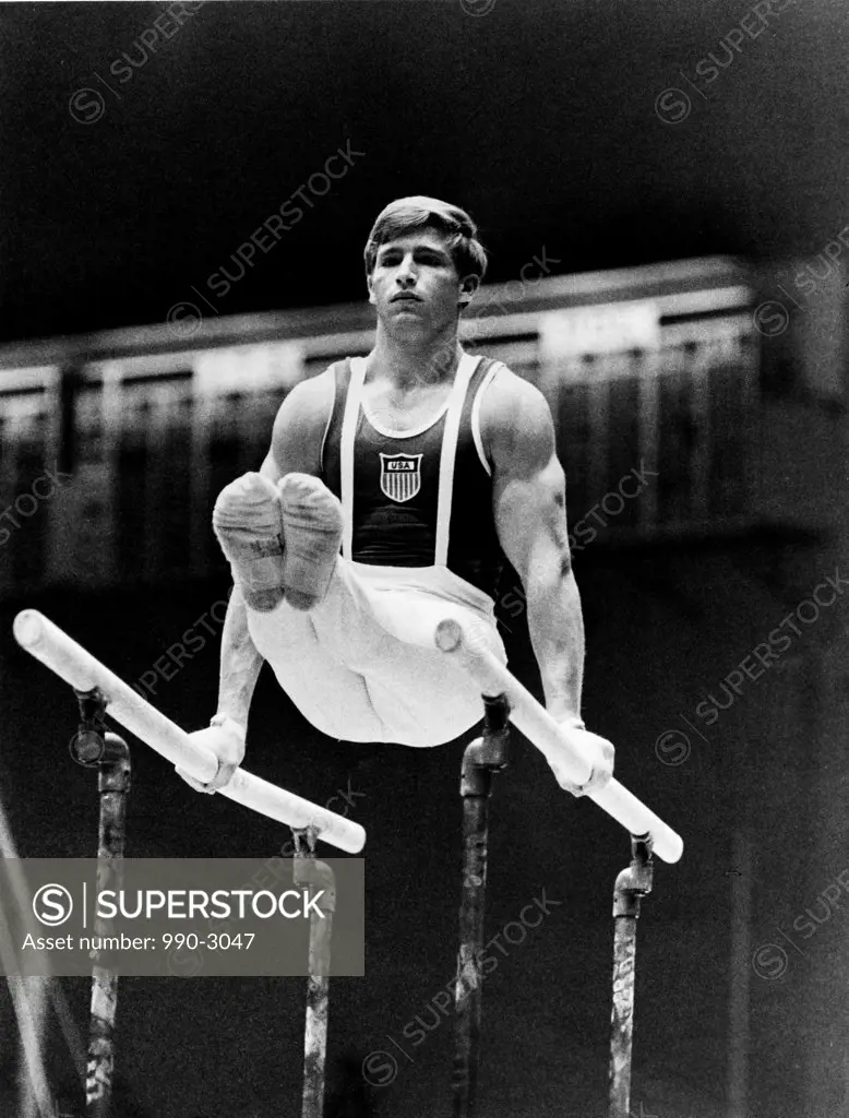 Young man performing on parallel bars at the Olympic games