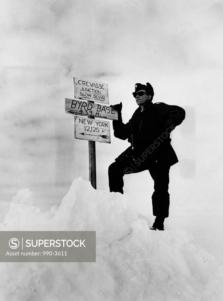 Antarctica, man standing near information sign