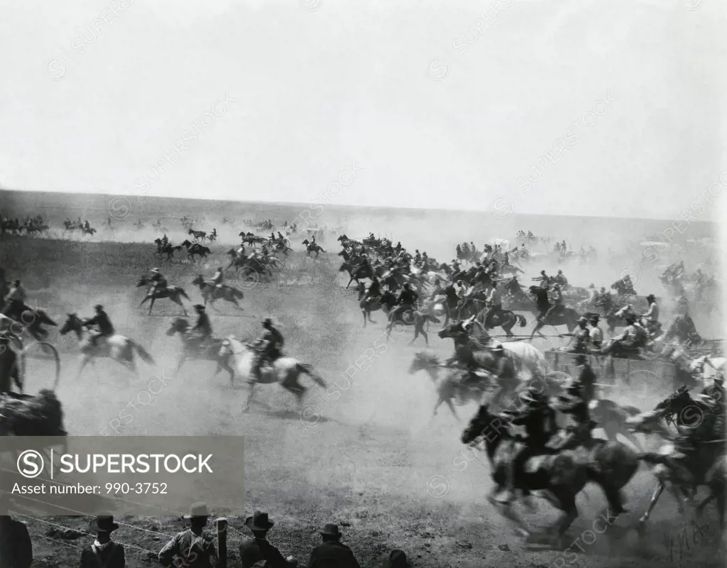 Group of cowboys riding horses, USA