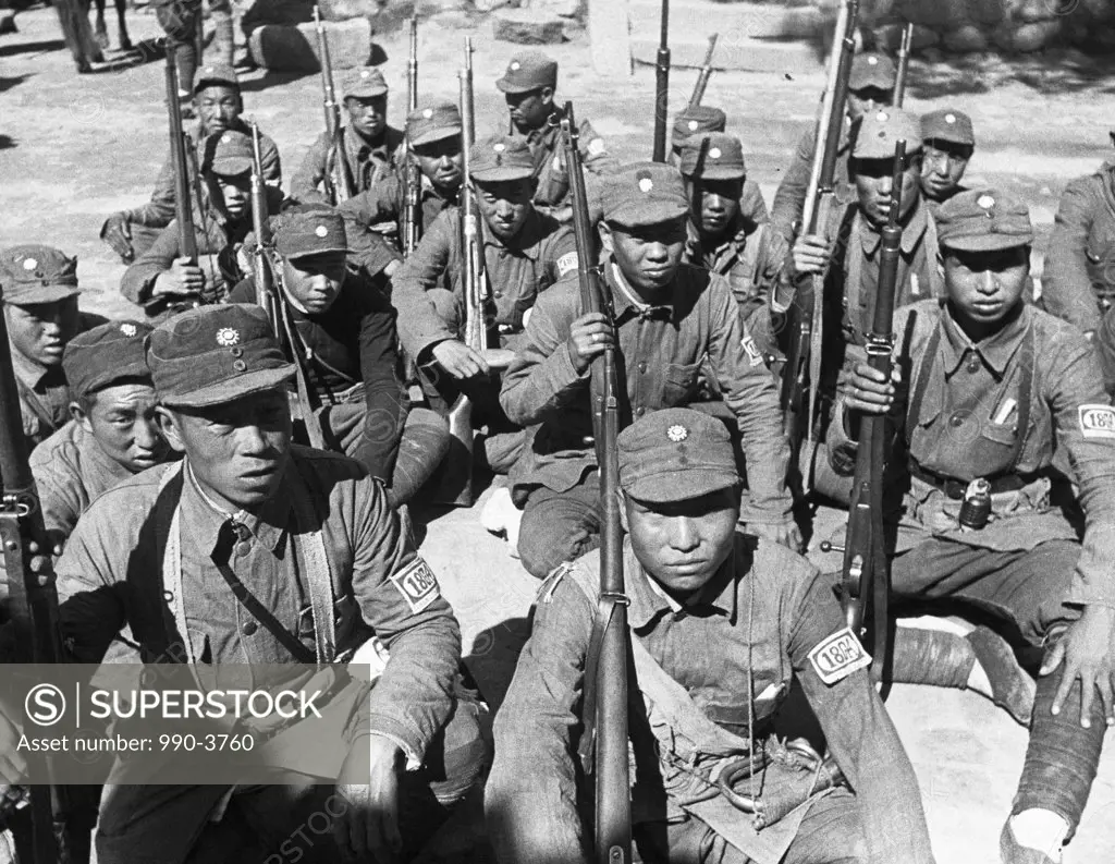 Chinese Red Army soldiers sitting with rifles, China