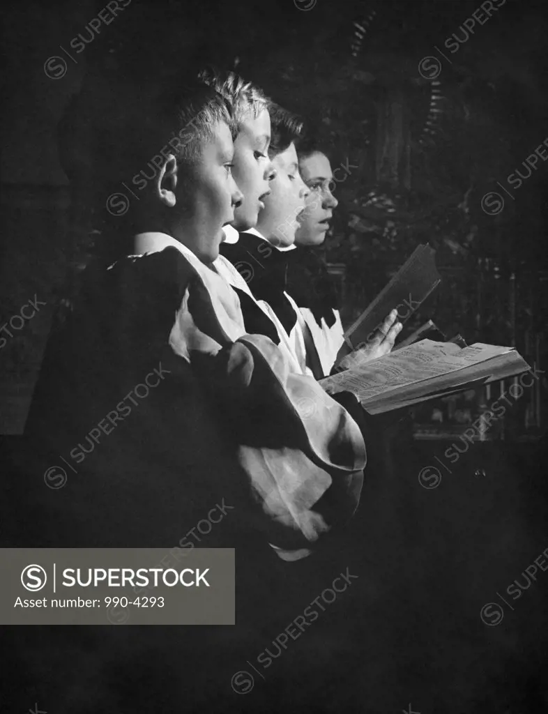 Four boys praying in a church