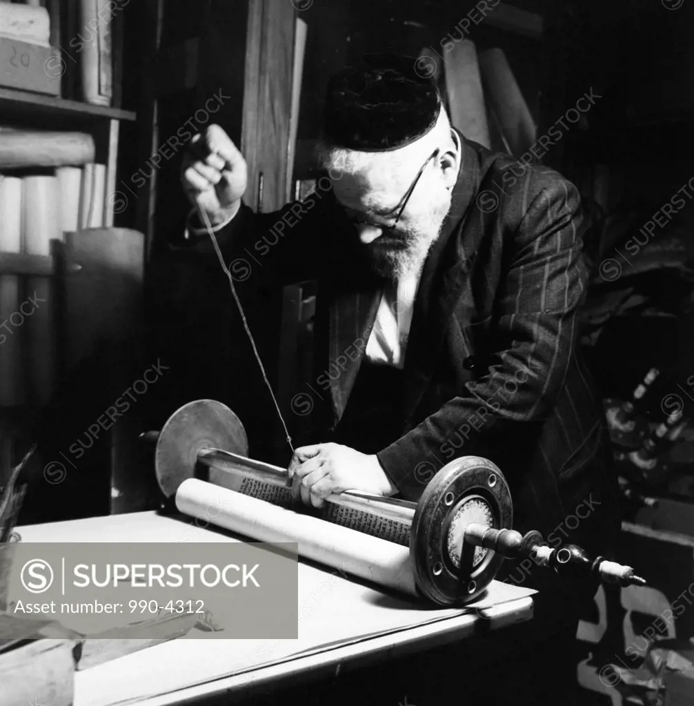 Jewish senior man preparing Torah scroll