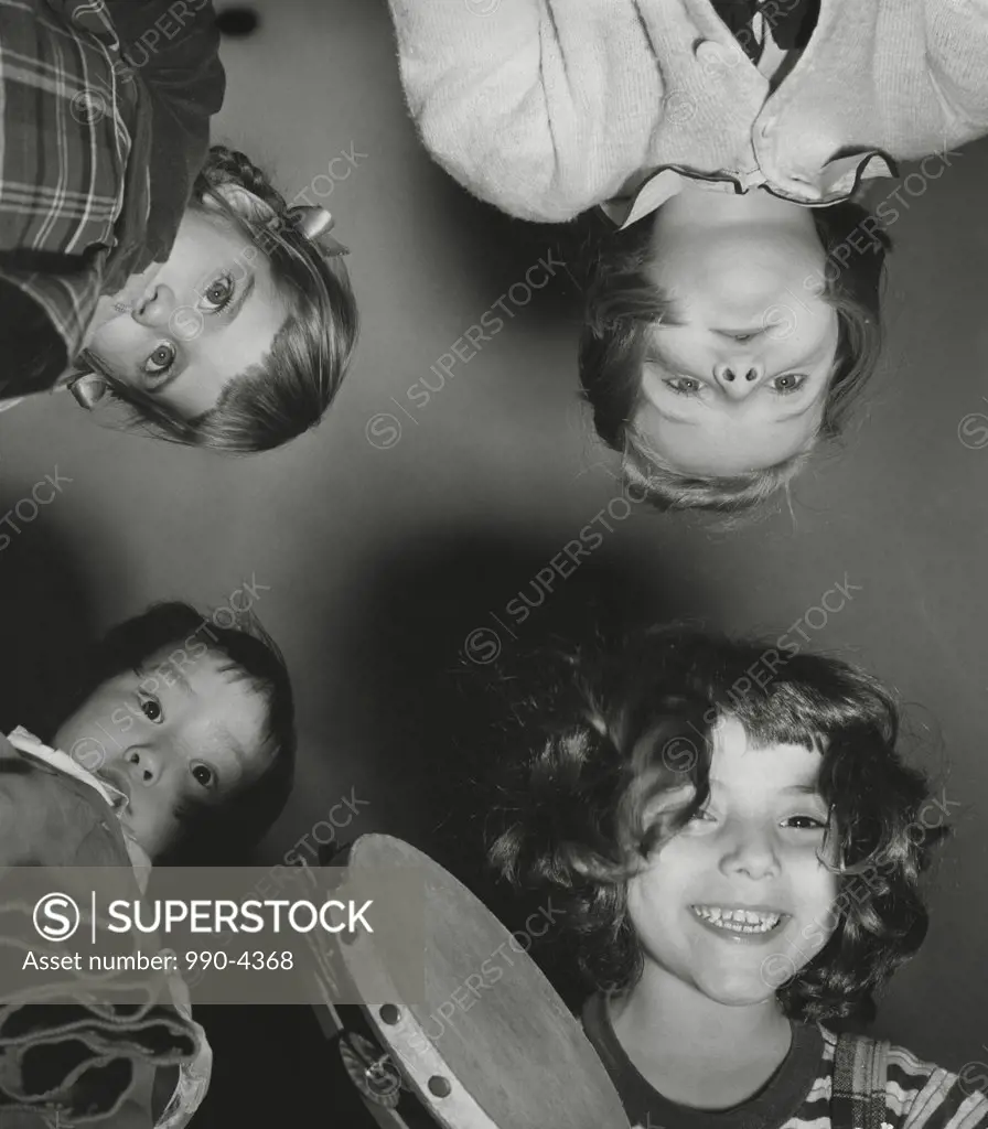 Low angle view of children holding a tambourine
