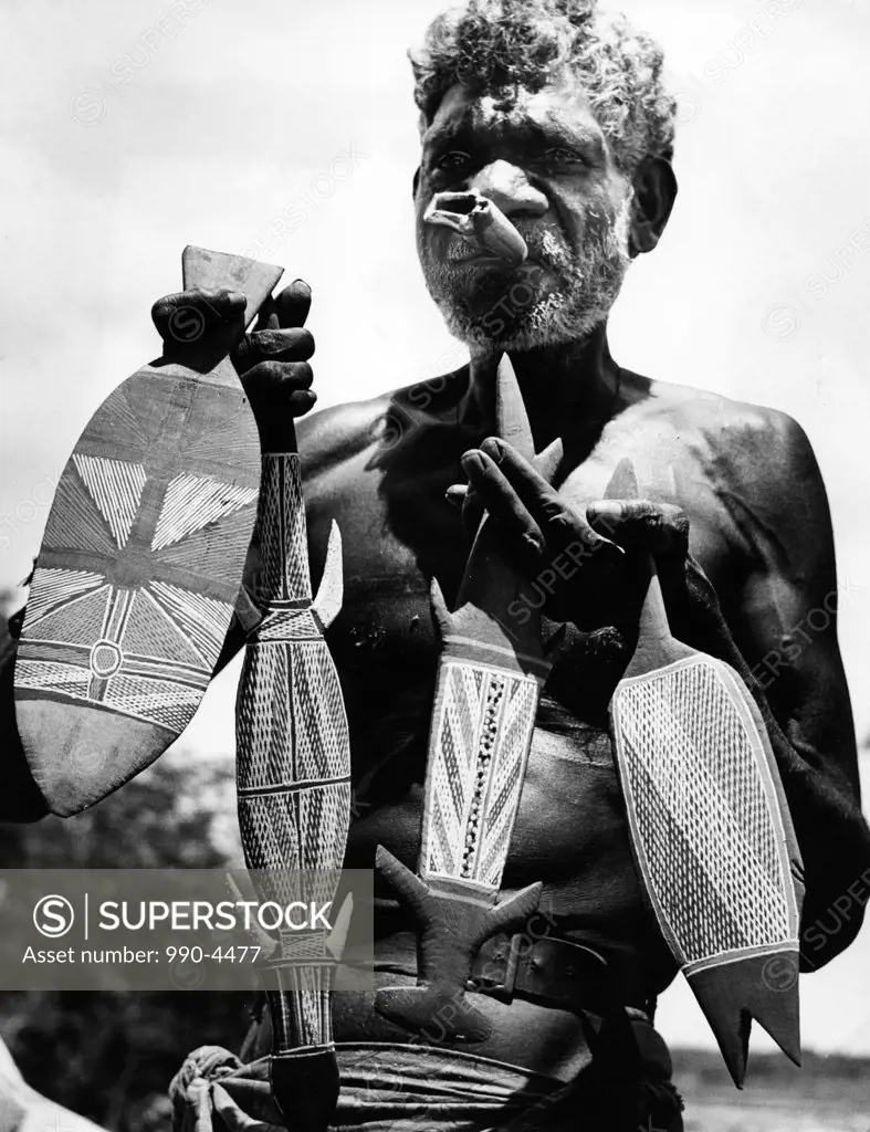Aborigine, Australia, senior man holding tribal sculptures
