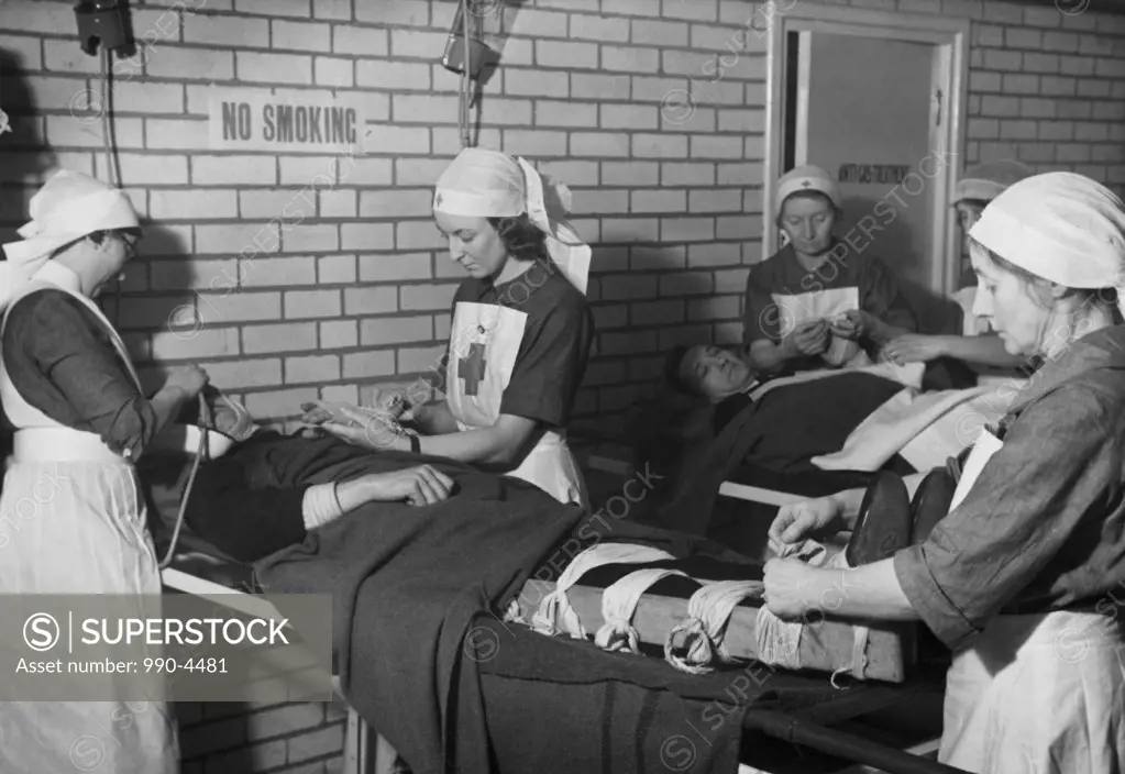 Group of female nurses giving treatment to patients