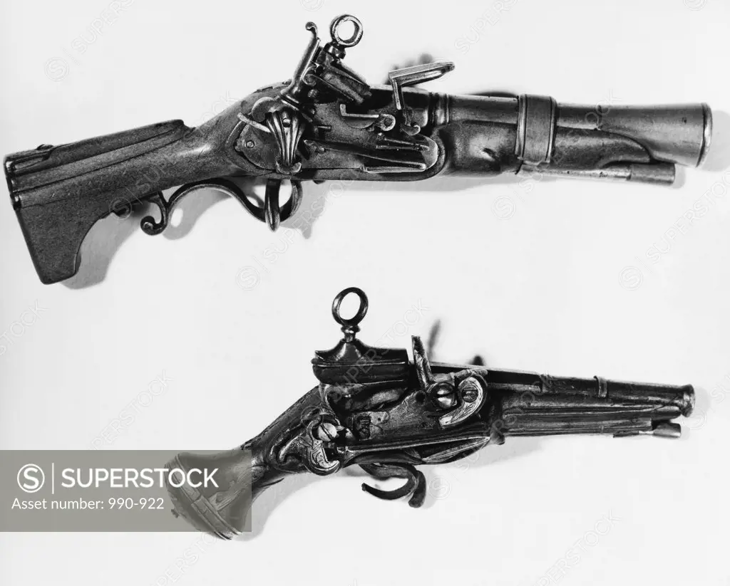 Close-up of a blunderbuss and a pistol